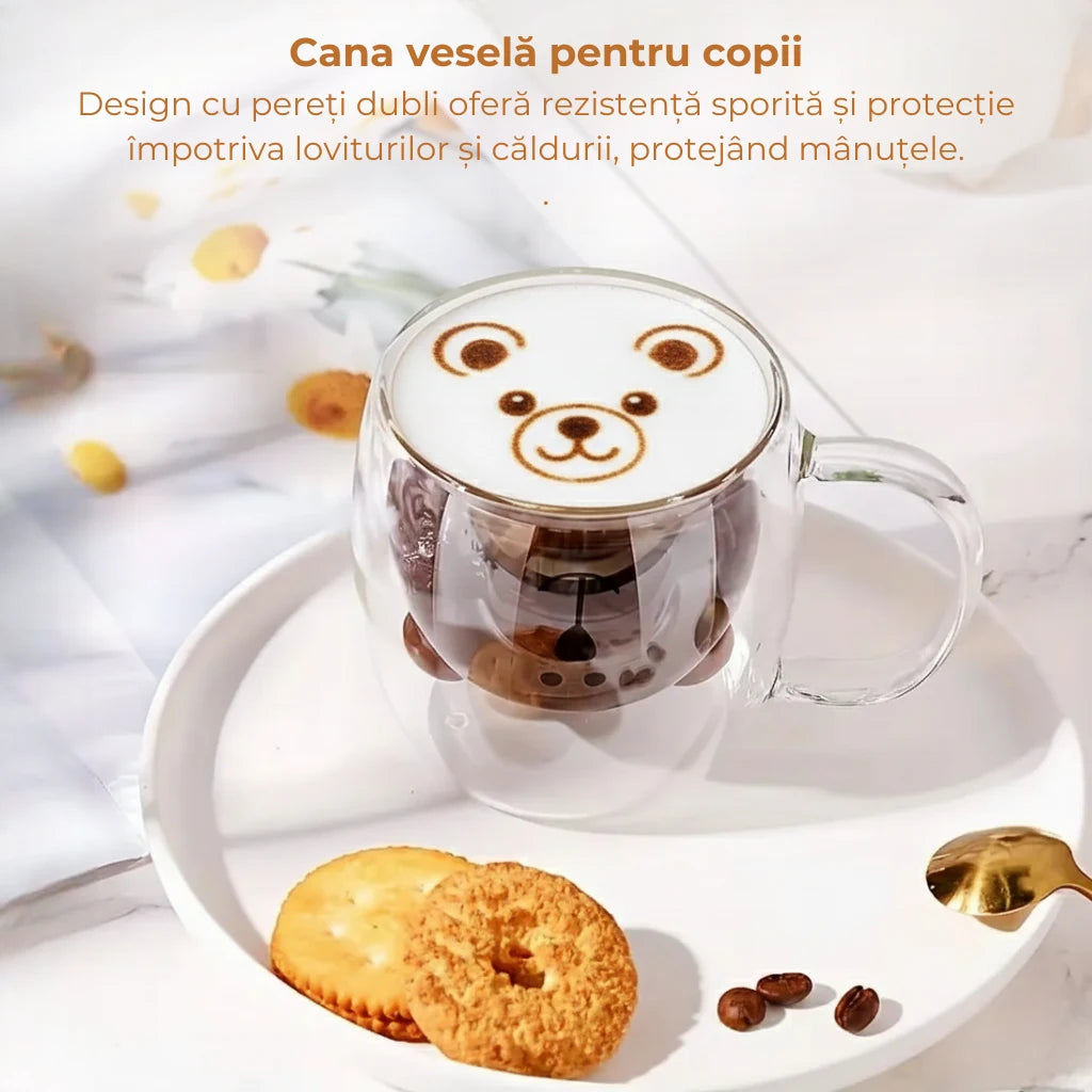 Cana in forma de urs cu ciocolata calda si lapte spumos pe care este desenat un ursulet din cafea. Cana sta pe o farfurie alba cu biscuiti si o lingura aurie. Pe poza este scris cana vesela pentru copii. Design cu pereti dubli ofera rezistenta sporita si protectie impotriva loviturilor si caldurii, protejand manutele.